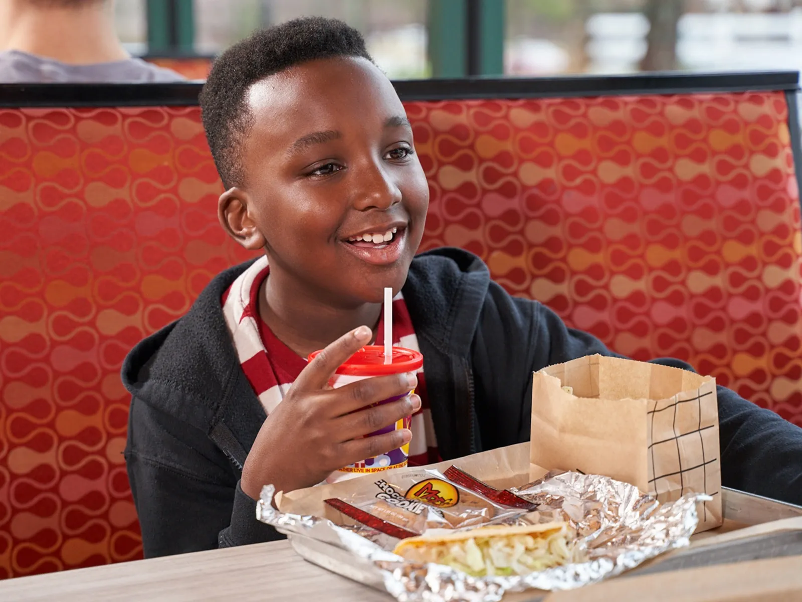 Boy smiling with Moe's cup